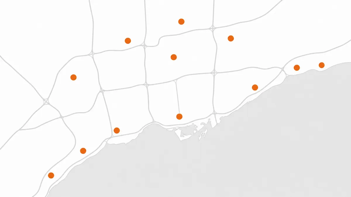 Illustrated map of the Greater Toronto Area along Lake Ontario with the 12 service cities marked in orange